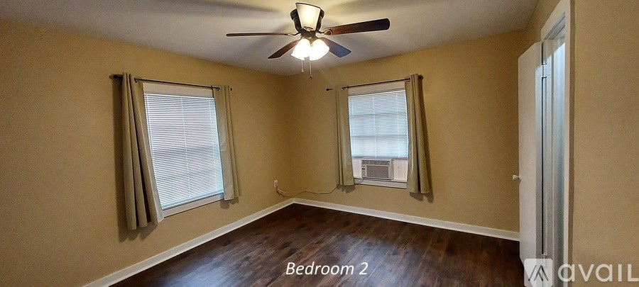 Bedroom 2 has a ceiling fan and two windows.