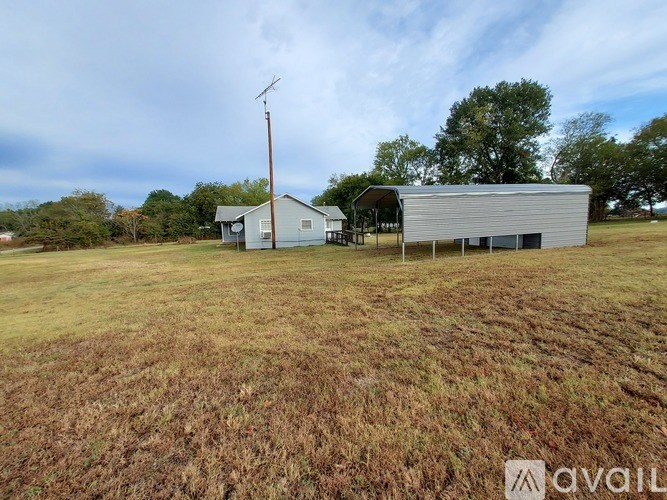 A rural scene with a house and a barn.