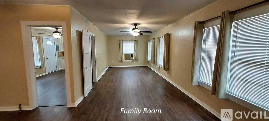 A long hallway with a family room at the end.