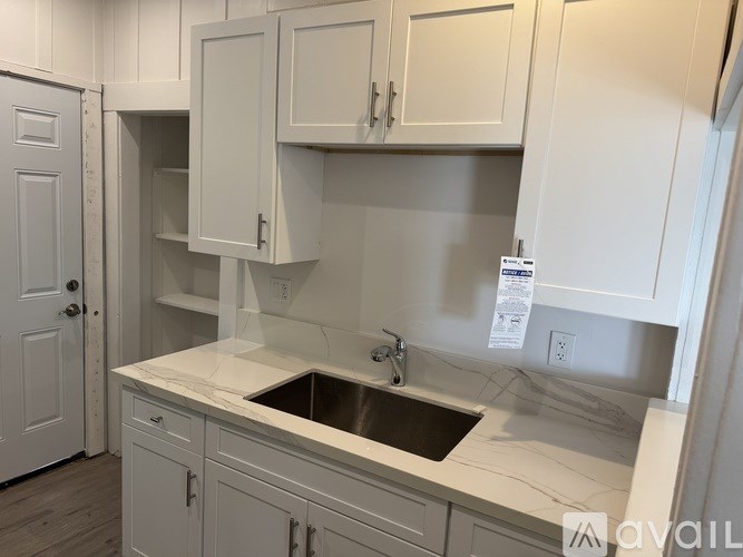 A house with a car parked in front of it.