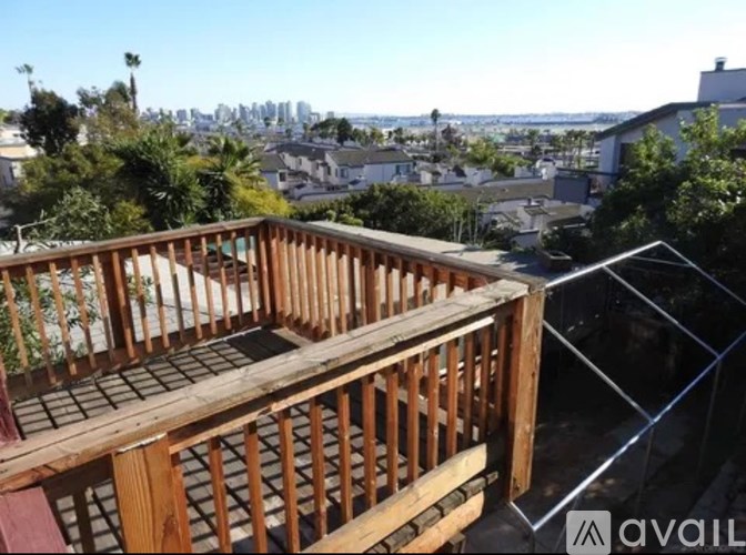 A wooden balcony overlooks a cityscape.
