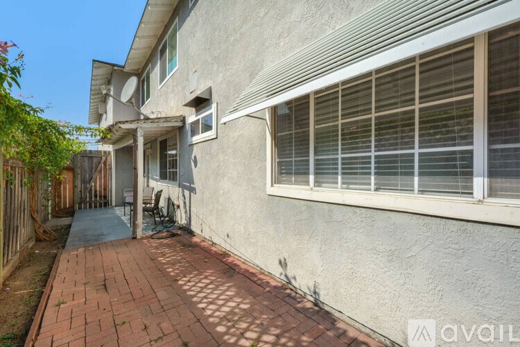 A house with a brick walkway leading to the front door.