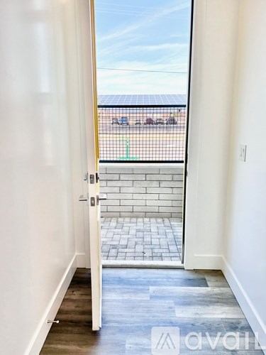 A view from inside a room looking out to a balcony with a railing.