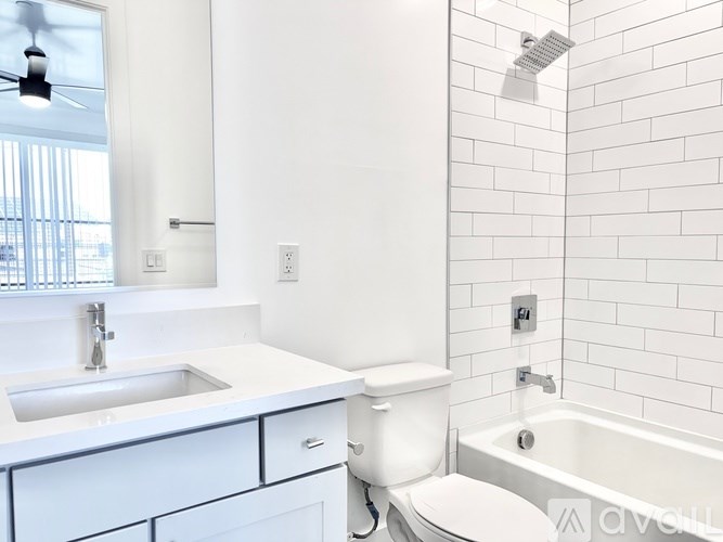 A white bathroom with a sink, toilet, and bathtub.