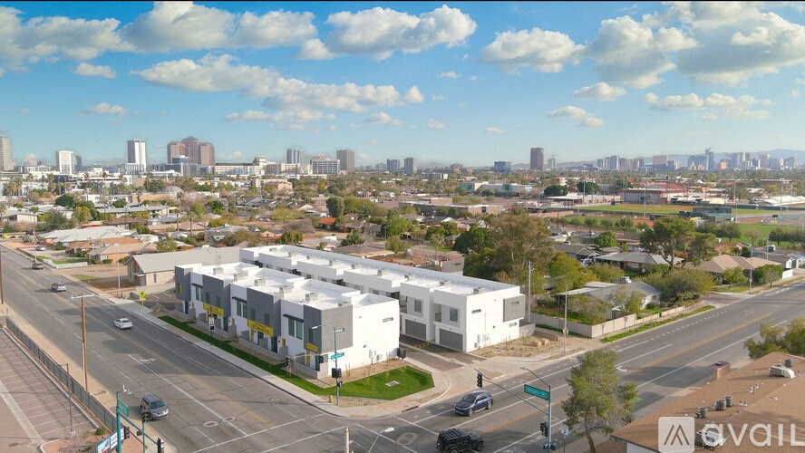 A cityscape with a clear sky and buildings in the distance.