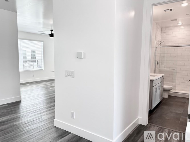 A white bathroom with a toilet and a shower.