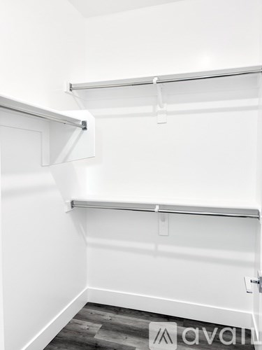 A white closet with a sliding door and a shelf.
