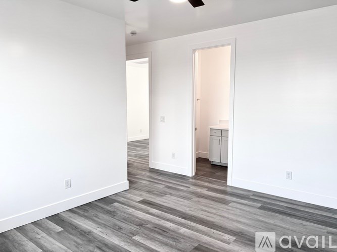 A room with a wooden floor and white walls.
