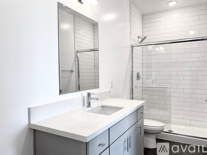 A bathroom with a white sink and a mirror above it.
