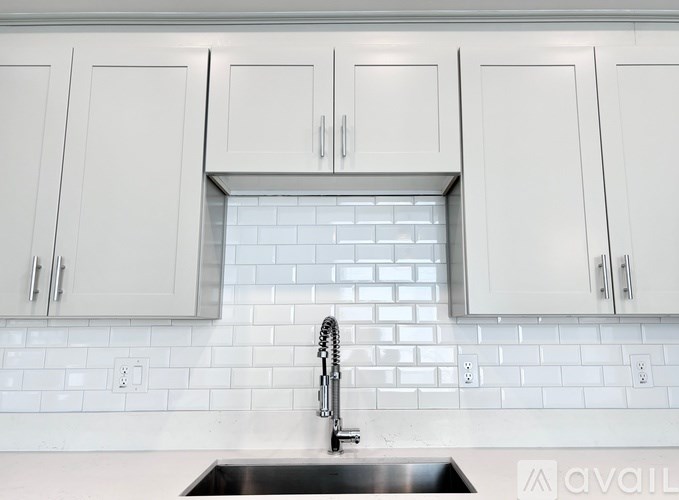 A kitchen with a sink and cabinets.
