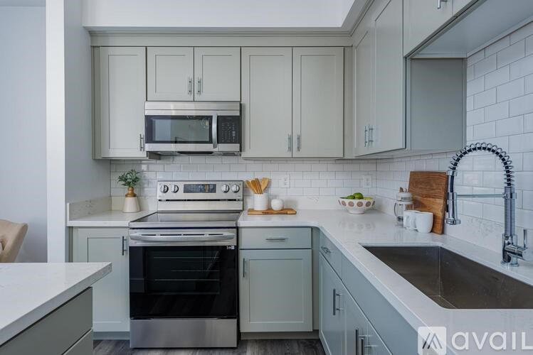 A kitchen with a stove, oven, and sink.