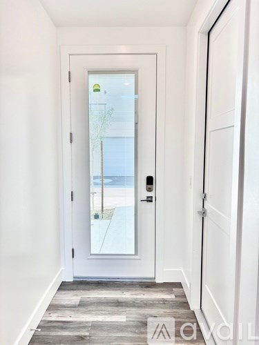 A white door with a glass window and a handle.