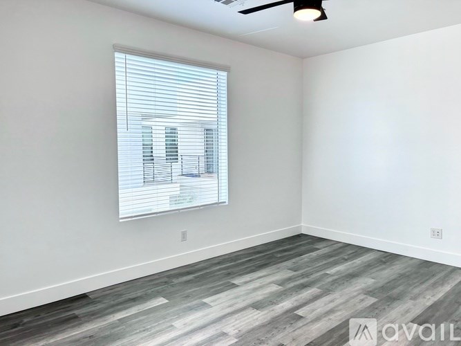 A room with a window and a ceiling fan.