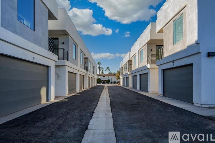 A row of modern houses with garages on the side.
