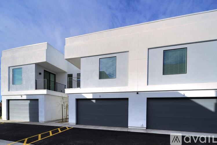 A modern two-story house with a garage on the ground floor.
