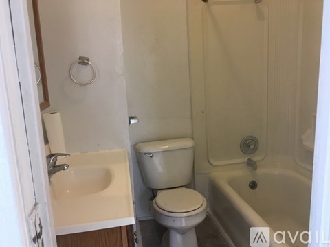 A white toilet sits next to a sink in a small bathroom.