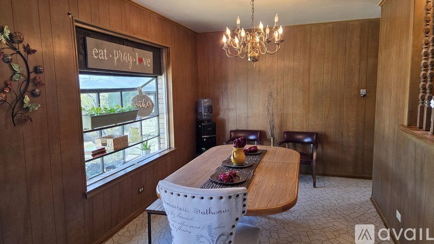 A bedroom with a bed, nightstand, and lamp.