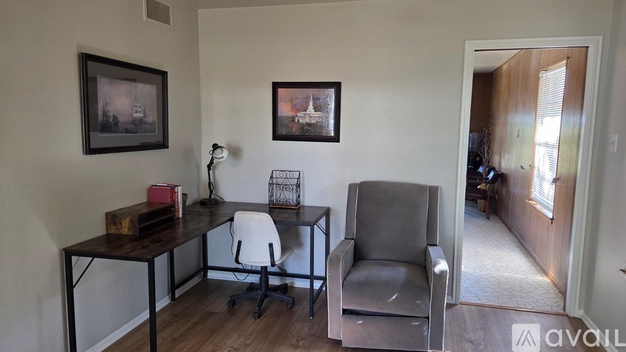 A white walk in closet with shelves and a mirror.