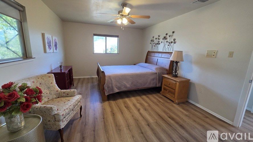 A white bathtub in a bathroom with a shower head.