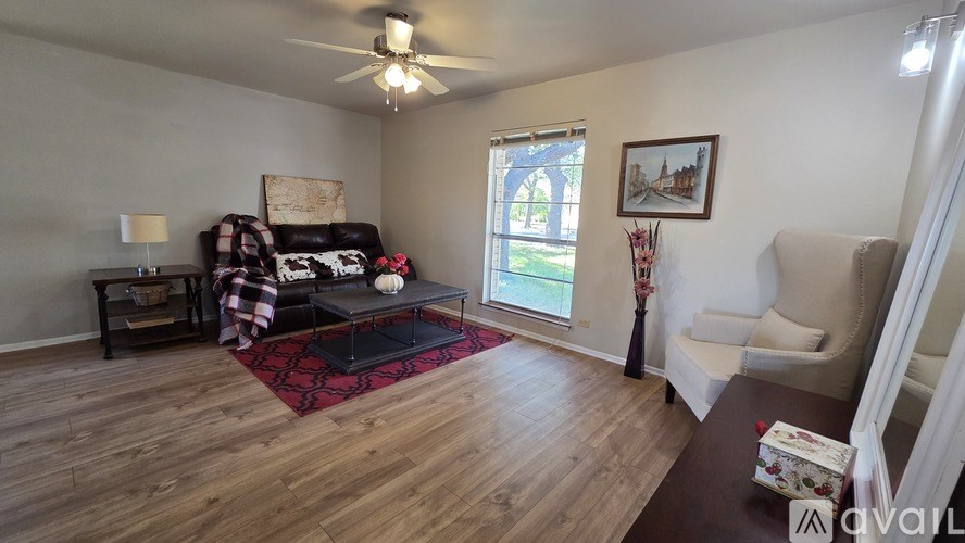 A kitchen with wooden cabinets and a tiled floor.