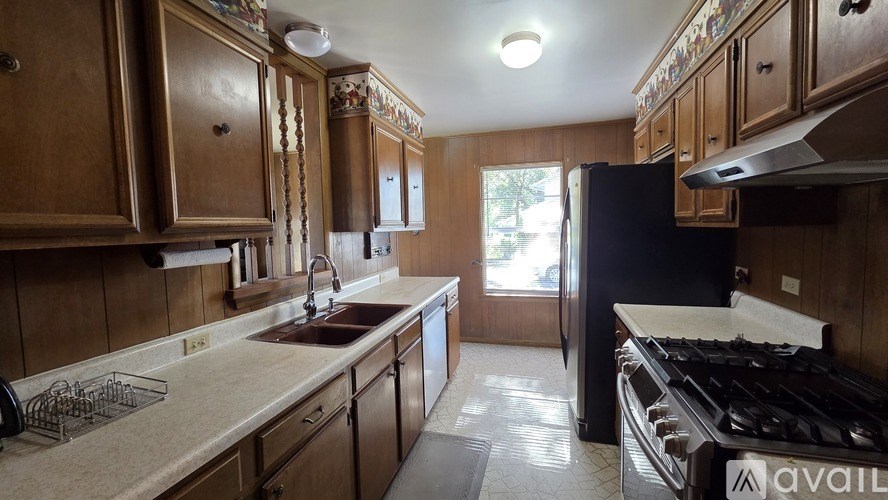 A bedroom with a bed, a chair, and a lamp.