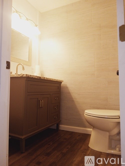 A bathroom with a toilet and a cabinet.