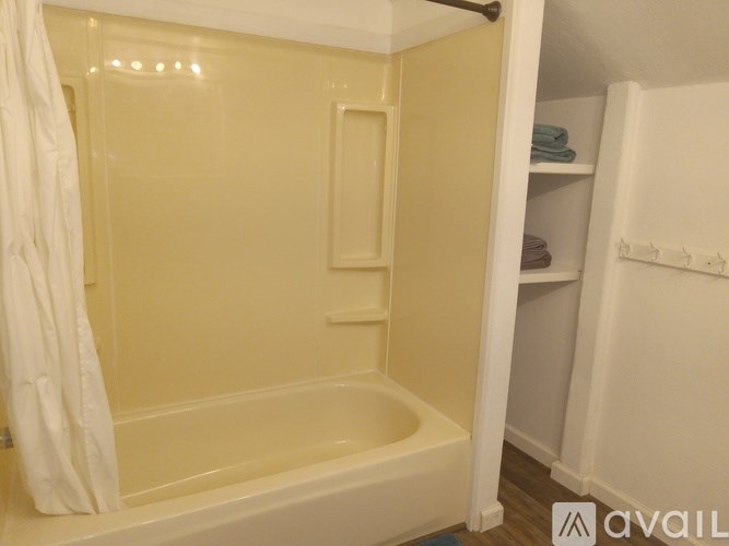 A bathroom with a bathtub and a shower stall.