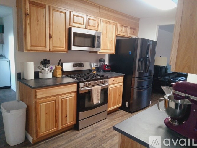 A kitchen with wooden cabinets and black appliances.