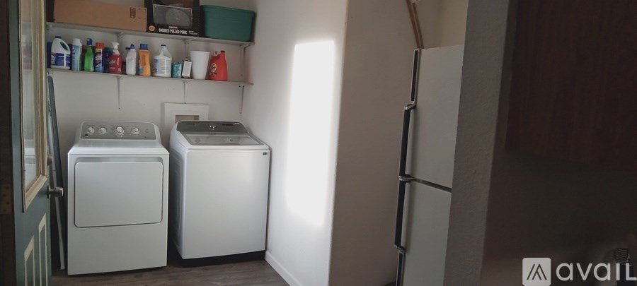 A small laundry room with a washer and dryer.