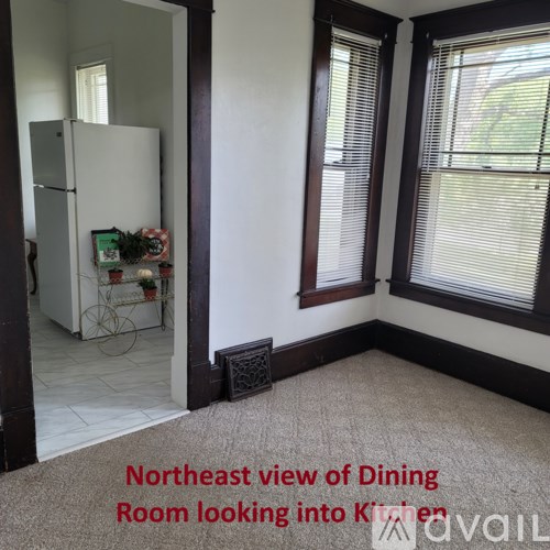 A dining room looking into a kitchen.