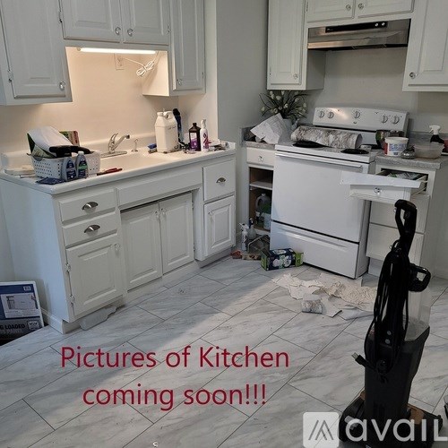 A kitchen under renovation with a lot of debris on the floor.