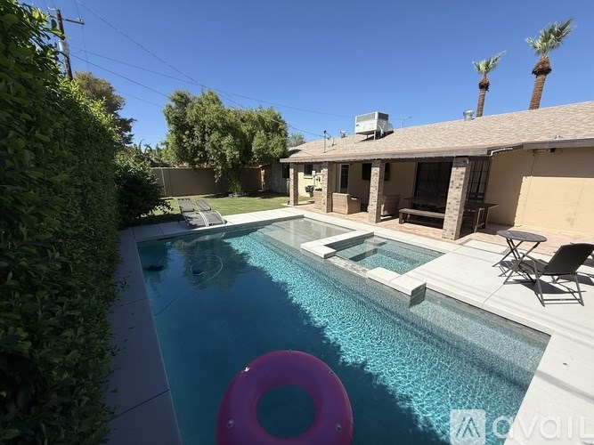 A pool with a pink float in the middle of it.