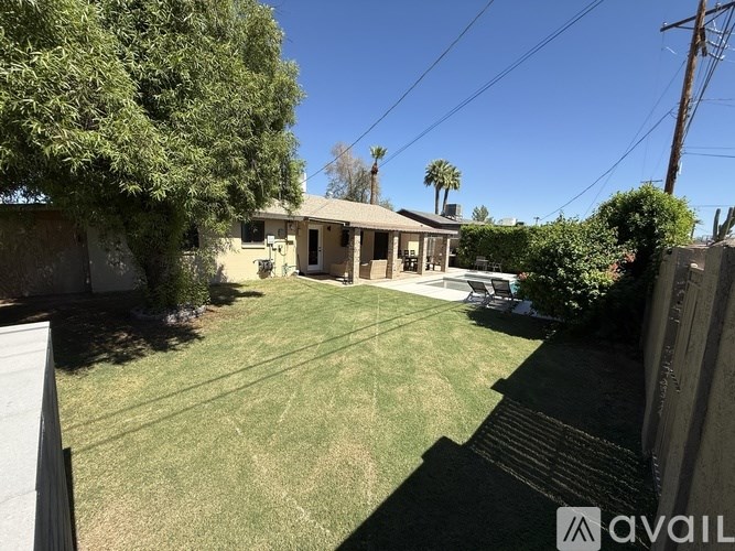 A house with a lawn and trees in the background.