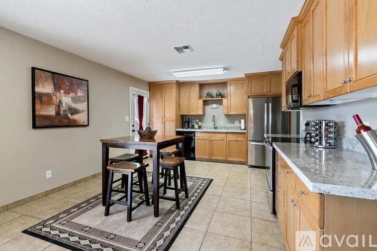 A kitchen with a table and chairs in the middle of the room.