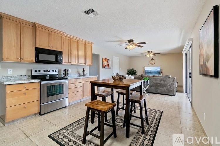 A kitchen with wooden cabinets and a stainless steel oven.