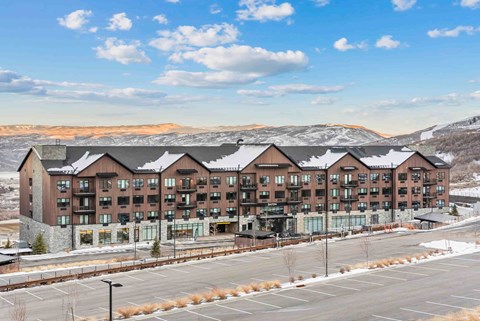 A large building with a parking lot in front of it.