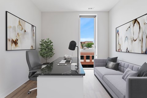 A modern living room with a black and white abstract painting on the wall.