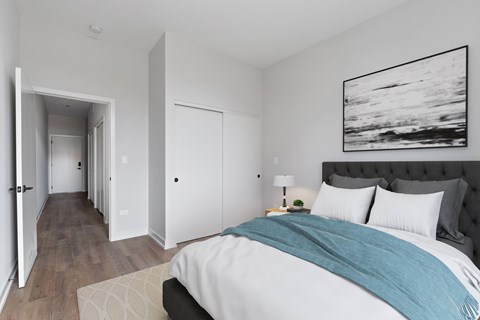 A bedroom with a large bed and a painting on the wall.