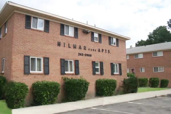 a brick building with the name apartments on it