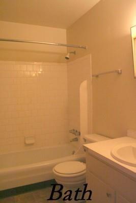 a bathroom with a toilet and a tub and a sink