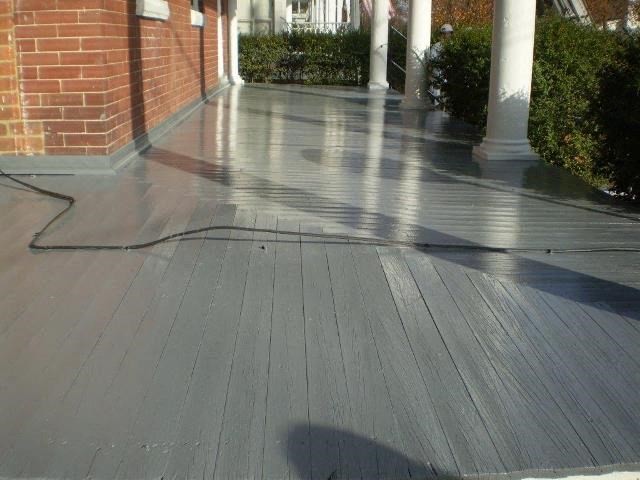 A wooden deck with a hose on it.