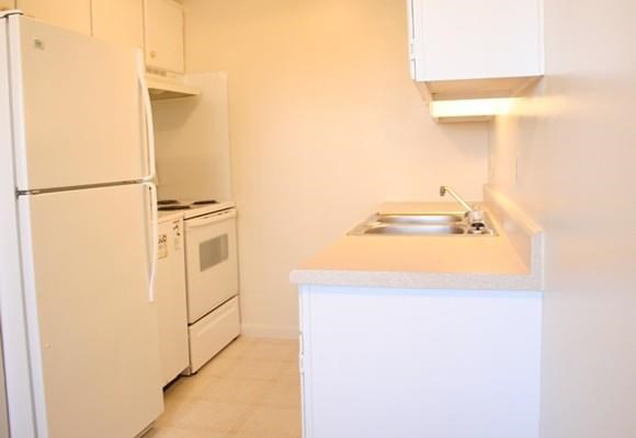 a kitchen with a sink and a refrigerator
