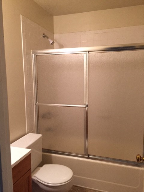 a bathroom with a toilet and a shower