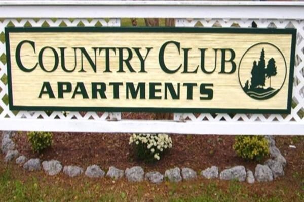 Entrance Sign a sign for the county club apartments