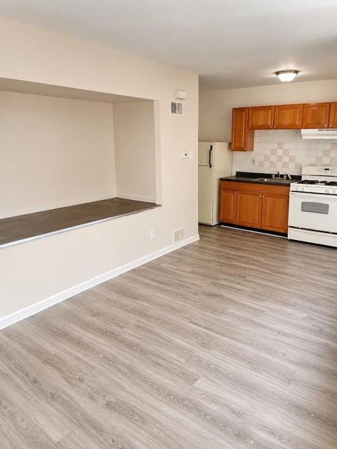A kitchen with wooden cabinets and a checkered backsplash.