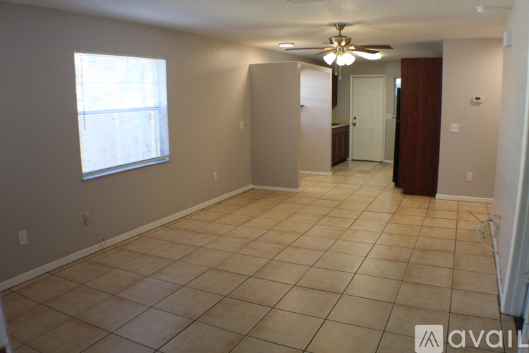 A room with tiled flooring and a ceiling fan.