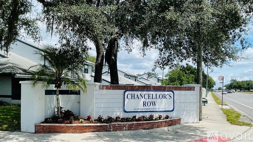 A sign that says Chancellor's Row in front of some houses.