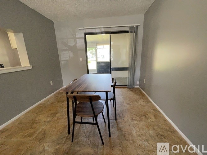A dining room with a table and chairs.