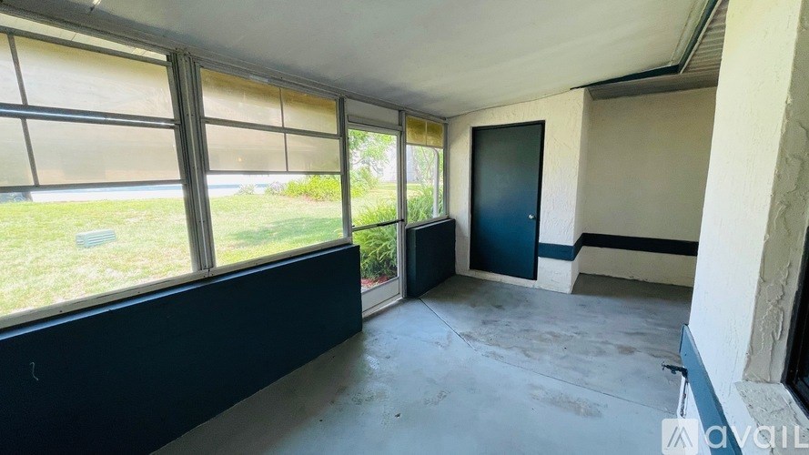 A room with a large window and a door.