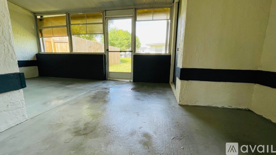 A room with a concrete floor and a large window.